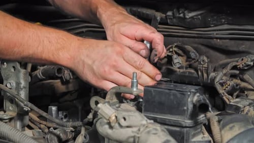 The Mechanic Tightens the Bolts with a Tool. Close-up in (UHD)