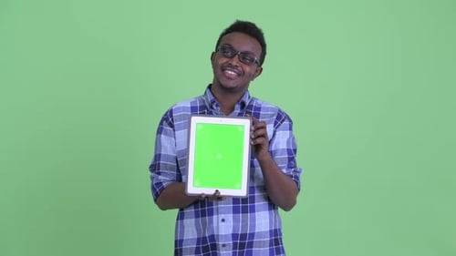 Young Adult Holding Tablet With Green Screen