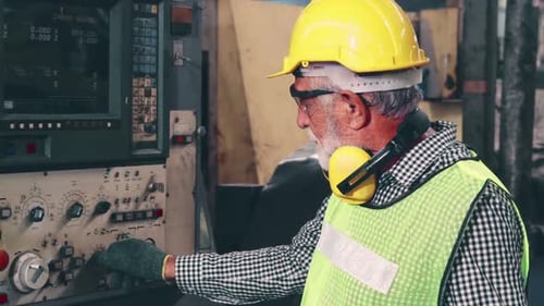Senior Factory Worker Teach How to Use Machine Equipment in the Factory Workshop