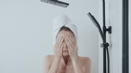 Woman Washing Her Face in the Shower