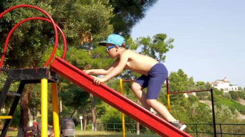 Outdoor Children Activities. Kid Climbing Slider at Playground