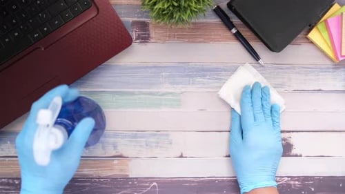 Disinfecting a Desk with Gloves and Wipes