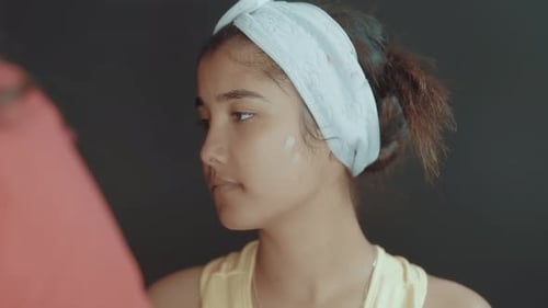 Woman Receives Facial Cream Application