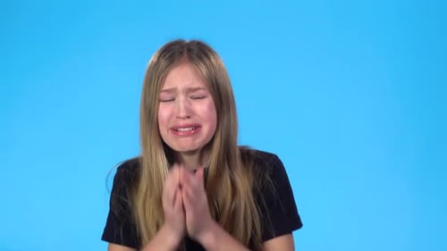 Girl Is Looking Scared and Crying, Looking at the Camera.