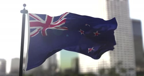 New Zealand Flag Waving in Slow Motion with City Background