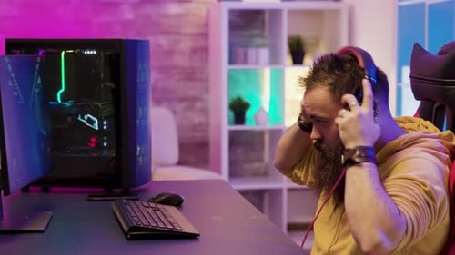 Bearded Man Playing Video Game at Computer