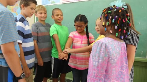 Diverse Children in Classroom Celebratory Hand Stack
