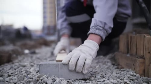 footage of builder installs curb