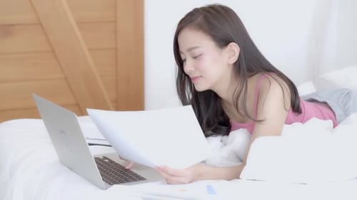 Businesswoman analyzing graph and chart finance of marketing with data on laptop computer.