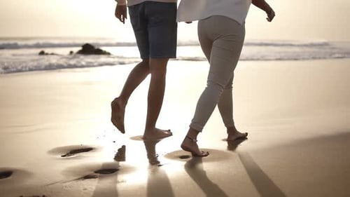 Honeymoon Married Young Couple on Beach Walking in Love Holding Hands at Romantic Sunrise