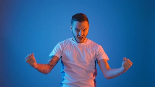 Man Celebrating with Fists and a Shout
