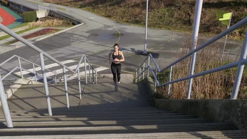 Woman Runs Up Concrete Steps Outside