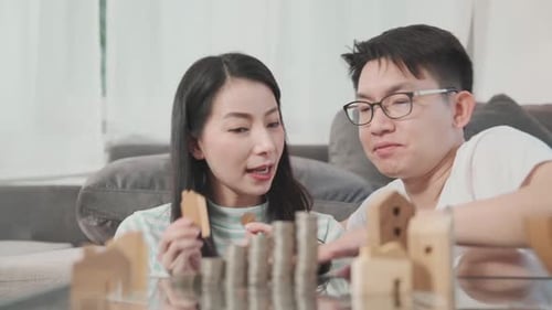 young attractive male and female asian couple focus concentrate money savin