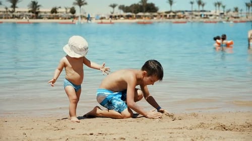 Two Young Boys Playing on Beach in Summer