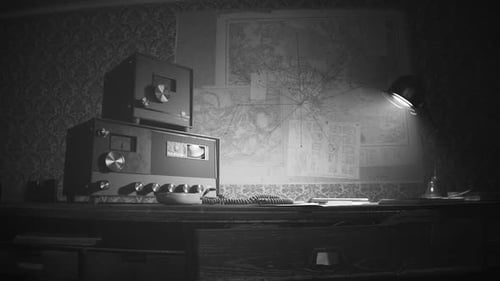Retro room with vintage radio station standing on the desk under obsolete lamp.