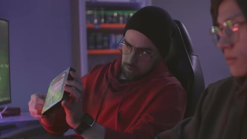 Two Multiethnic Hackers Examining Hard Disk