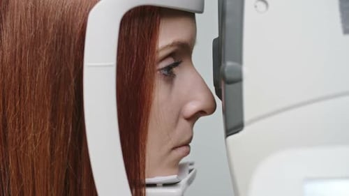 Woman Having Eye Exam with Clinical Machine