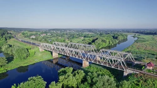 Train Bridge Crossing a River on a Bright Day
