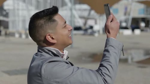 Young Adult Using Mobile Phone Outdoors