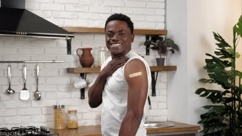 Man Smiles and Gives Thumbs Up After Vaccination