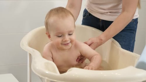 Cute Baby Bathing, Smiling in Tub at Home