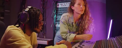 Cheerful Coworkers Discussing Music in Recording Studio