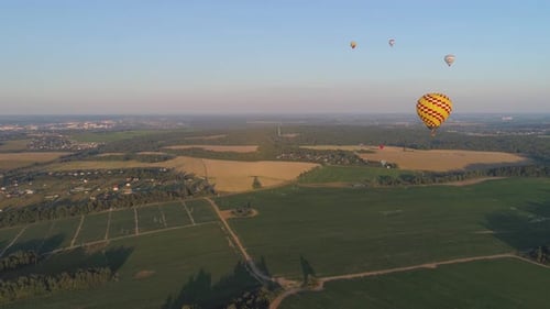 Hot Air Balloons Floating Over Countryside