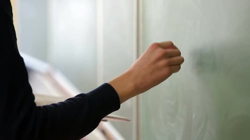 Writing on a Chalkboard in a Classroom