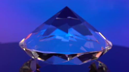 Sparkling Glass Diamond on Blue Reflective Surface