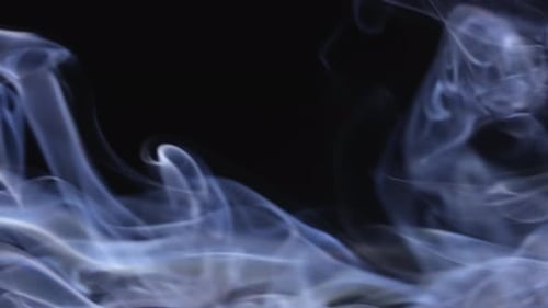 Wispy Smoke Flowing on Black Background