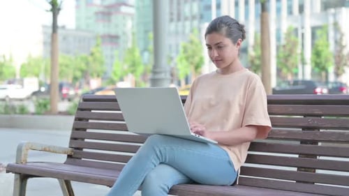 Busy Indian Woman Using Laptop in Office
