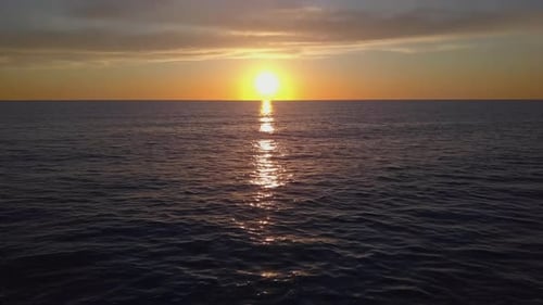 Aerial View Drone Flying Over Sea Surface in Evening Sun Light, Golden Hour Sunset, Cinematic Shot