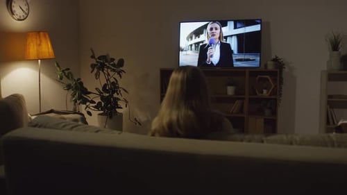 Woman Watching News in Evening