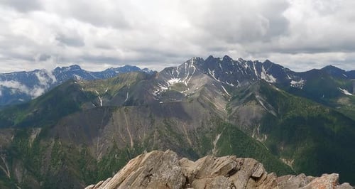 Timelapse Clouds Float Over High Rocky Mountains