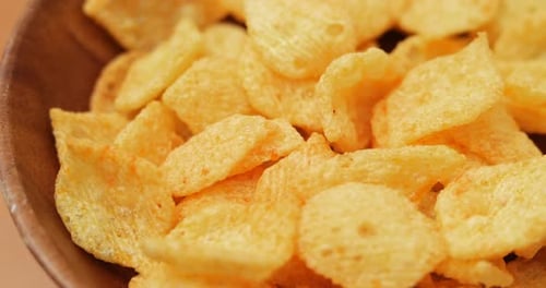 Golden Chips in Wooden Bowl Close Up