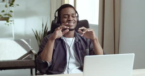 Man listening music with headphones in the home