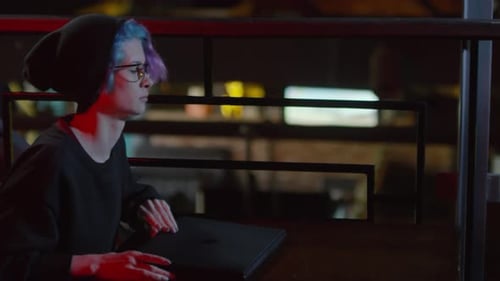 Female Programmer Working in Café