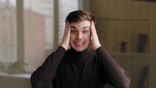 Young Man Excitedly Reacting to Good News