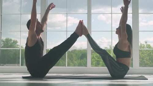 Wellness Man and a Woman Doing Yoga Together Perform Stands and Muscle Stretching Joint Training of