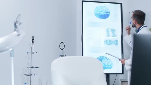 Doctor Analyzing Brain Scan on Interactive Display