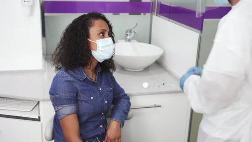 Healthcare Worker Prepares Syringe for Patient in Clinic