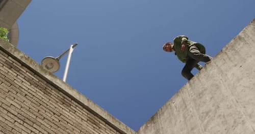 Young Man Jumps Between Concrete Walls