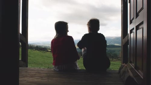 Children Relaxing on Porch Overlooking Mountain Scenery