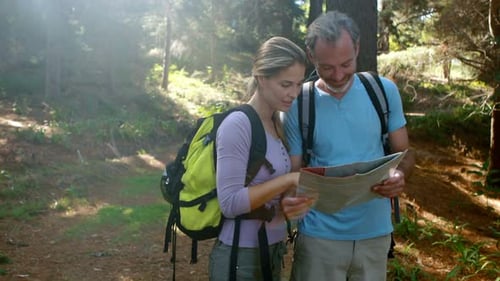Couple Hiker Looking at Map Together in Forest