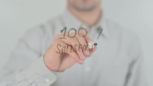 Man Writes 100% Satisfaction Guarantee on Clear Surface