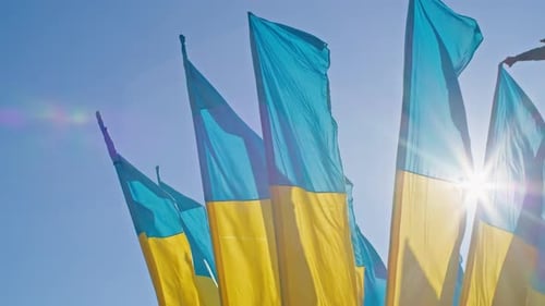Flags Waving Proudly against Clear Blue Sky