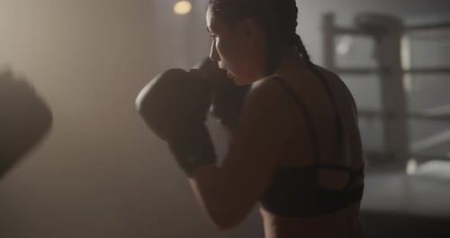 Woman Boxer Sparring with Trainer in Gym