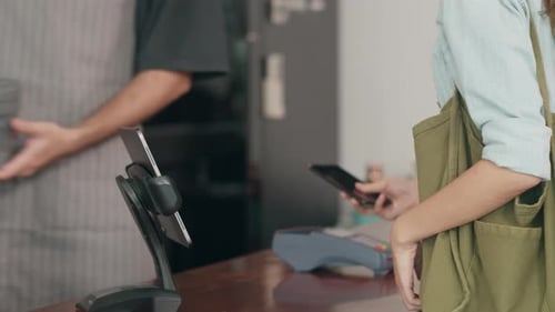 Customer Makes Mobile Payment at Coffee Shop