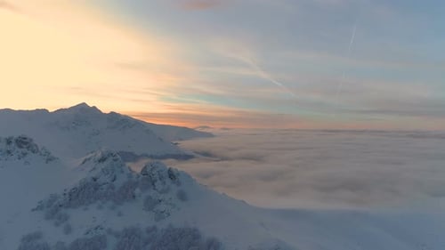 Aerial View of Snowy Mountains at Sunrise