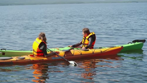 People Kayaking Together on Lake During the Day